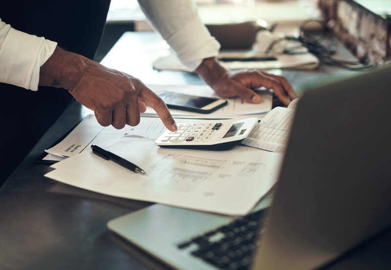 Hands reviewing figures at a fee-audit workspace